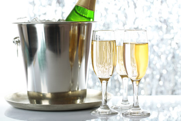 Glasses of champagne on bright background
