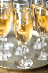 Glasses of champagne on bright background