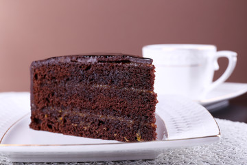 Piece of chocolate cake on white plate, closeup