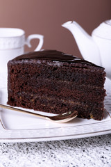 Piece of chocolate cake on white plate, closeup