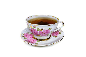 cup with roses on a white background closeup