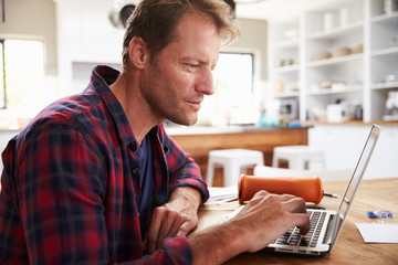 Man working on laptop at home