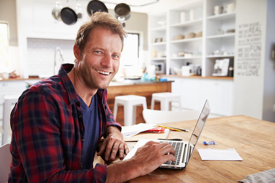 Man Working On Laptop At Home