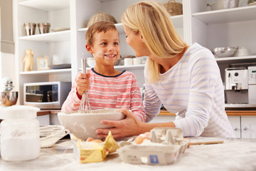 Mother and son baking together at home