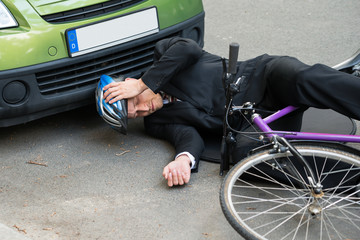 Male Cyclist After Car Accident On Road