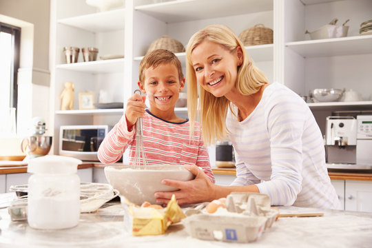 Mother and son baking together at home
