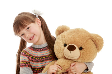 Charming girl with tails hugging a Teddy bear