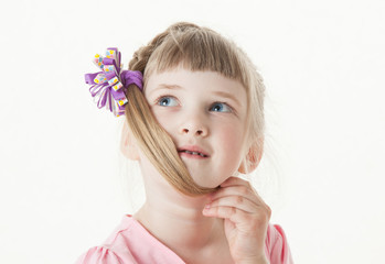 Portrait of a thinking little girl, white background