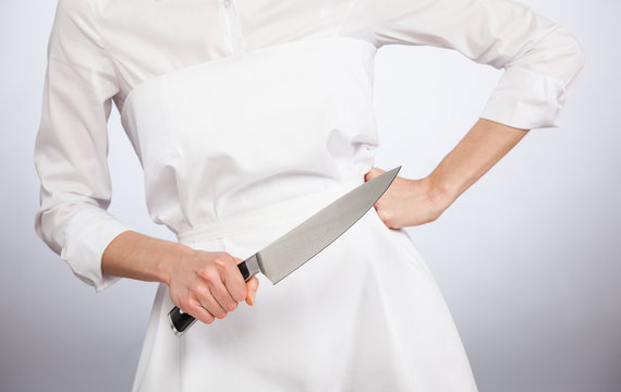 Cook holding a big kitchen knife