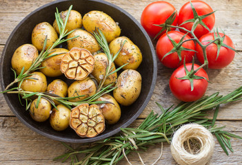 Small baked potato with rosemary  and  garlic