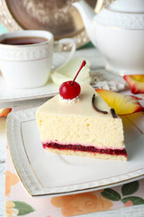 Tasty piece of cheesecake on plate on table close up