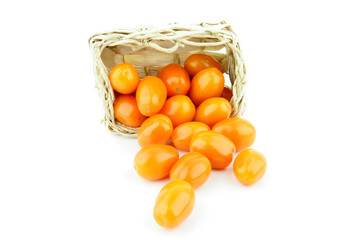 Orange tomatoes in a woven basket.