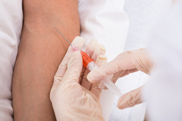 Doctor Taking Blood From Patient