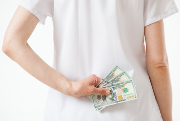 Doctor hiding money, white background