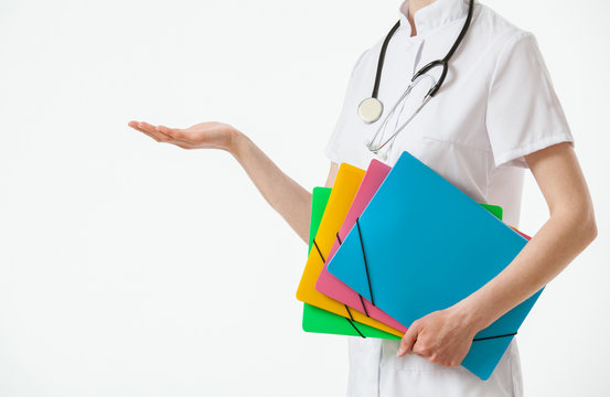 Unrecognizable doctor holding several folders and showing someth