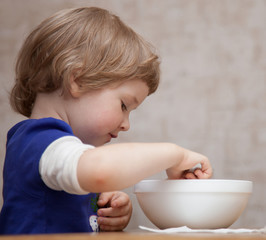 Pretty baby girl eating at home