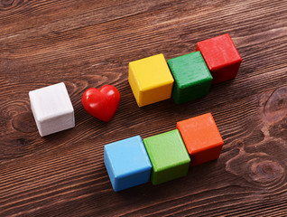 Colorful cubes for inscriptions on wooden background