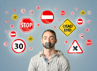 Young man with glued mouth and traffic signals