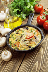 Omelet with mushrooms and tomatoes. Frittata
