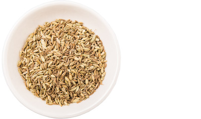 Cumin seed in white bowl over white background