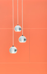 Fototapeta na wymiar Orange negative collage of three ceiling lights, loft-style inte