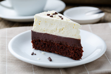 Vanilla cheesecake slice on wooden background.