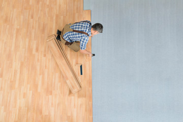 Worker Assembling New Laminate Floor