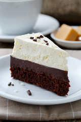 Vanilla cheesecake slice on wooden background.