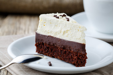 Vanilla cheesecake slice on wooden background.