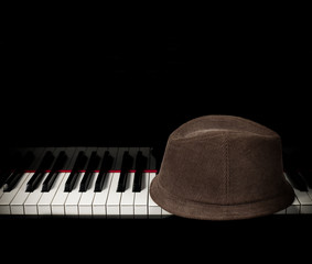 Hat on piano keyboard