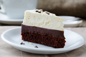 Vanilla cheesecake slice on wooden background.