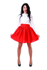 Beautiful young woman in a white blouse and a red skirt