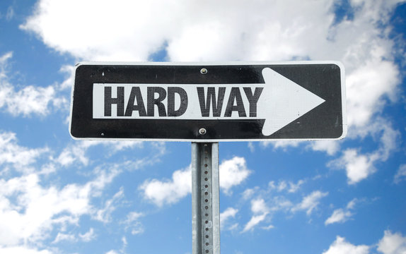 Hard Way direction sign with sky background