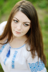 girl with freckles on her face in a Ukrainian shirt