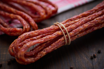 Sausage or kabanos and pepper on vintage wooden boards