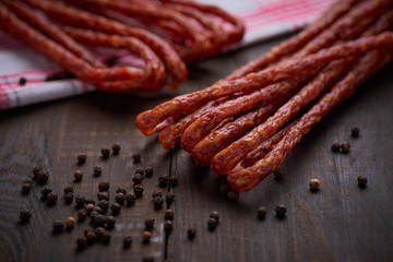 Sausage or kabanos and pepper on vintage wooden boards
