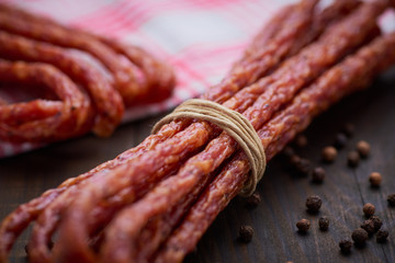 Sausage or kabanos and pepper on vintage wooden boards
