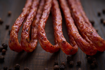 Sausage or kabanos and pepper on vintage wooden boards