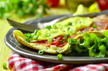 Omelet stuffed with tomatoes and cheese.