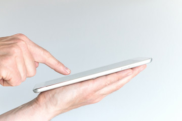 Male hand holding modern tablet or large smart phone