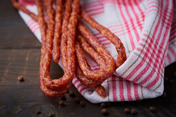 Sausage or kabanos and pepper on vintage wooden boards