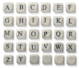 Alphabet letters on wooden pieces, isolated on white.