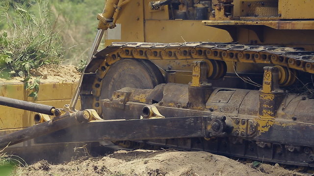 Unidentified worker control Bulldozer to excavator grader removing the ground