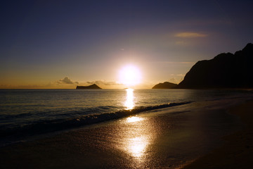 Naklejka premium Early Morning Sunrise on Waimanalo Beach over Rock Island bursti