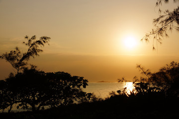 Fototapeta na wymiar Early Morning Sunrise on Waimanalo Beach over Rock Island bursti