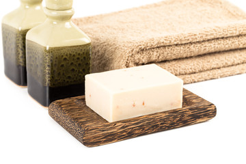 Hand made herbal soap in wooden dish with towel