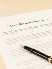 Last will on cream color paper and pen; document and information