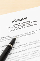 Resume with pen; resume and information are mock-up