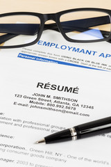 Resume with pen and glasses; resume, document, and information a