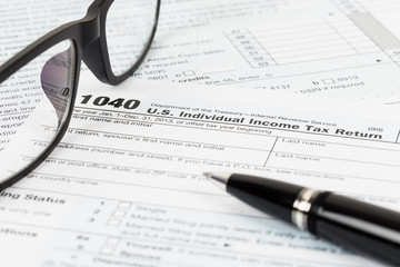 Tax form with glasses, and pen
